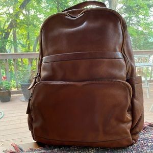 Women’s medium leather backpack with media charging interior connection.